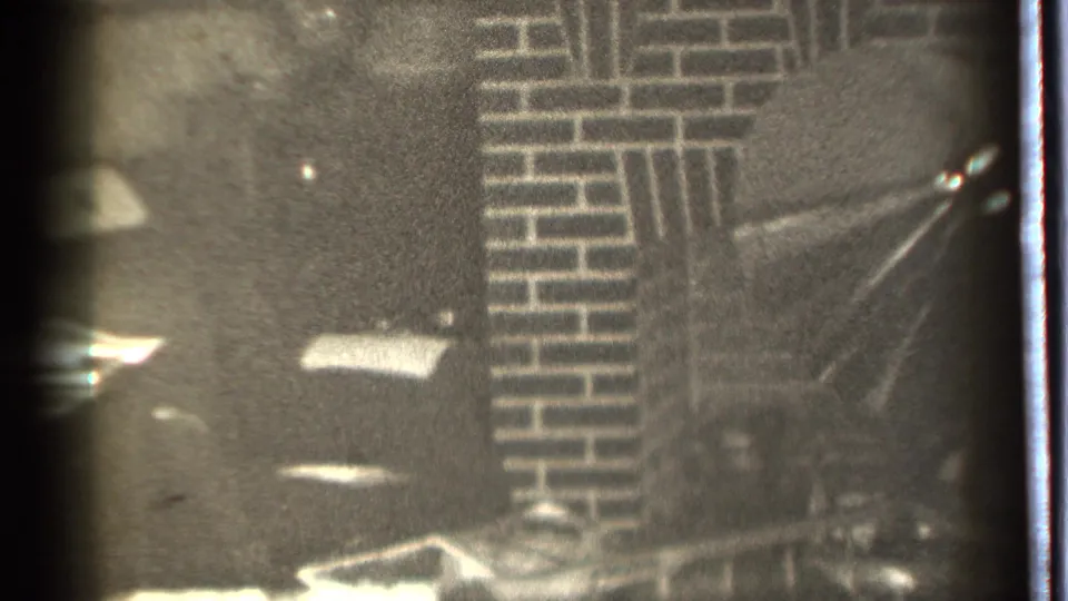 1939 Danielson, Connecticut 8mm frame showing a dark brick fireplace area with soft focus and film wear.