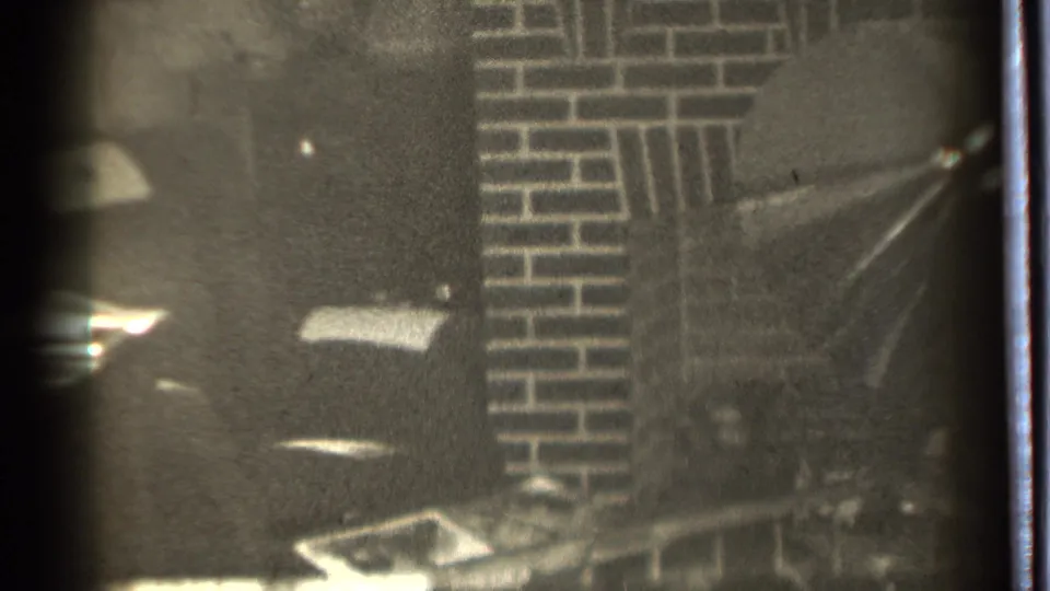 1939 black-and-white home-movie frame showing a dim brick fireplace area in Danielson, Connecticut.