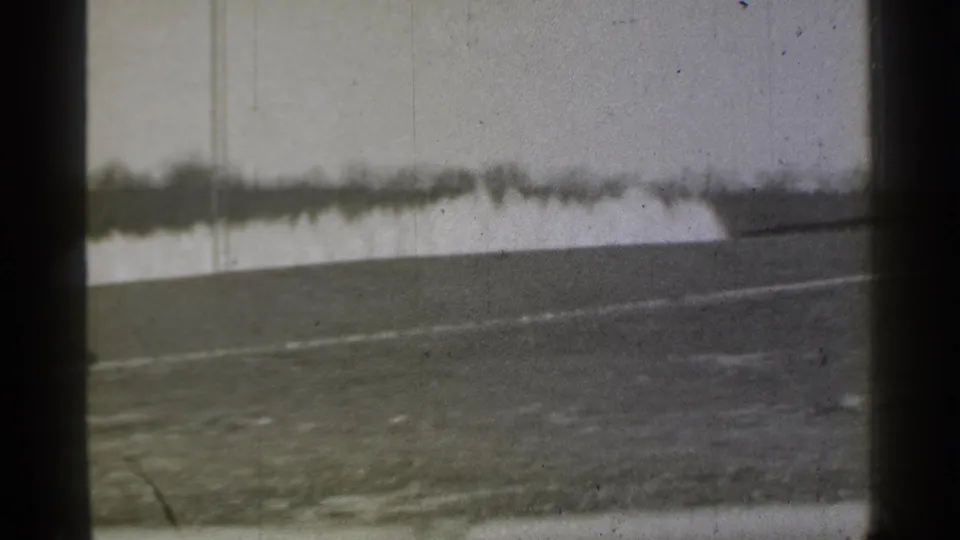 1939 Danielson, Connecticut footage showing a barren field, pale horizontal wall or fence line, and aged 8mm frame edges.