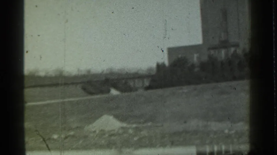 The end of the pan shows factory-like structures, open ground, scattered debris, and a pale mound in Danielson, Connecticut.