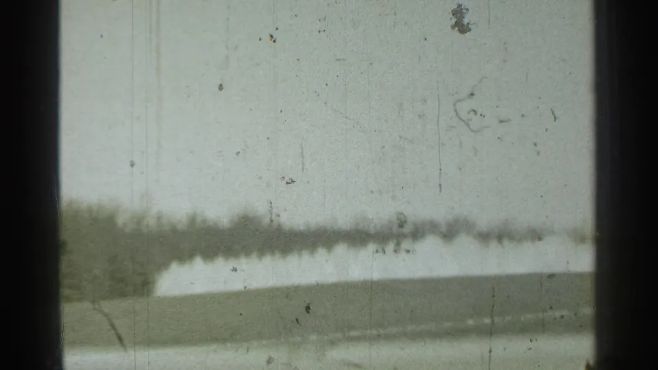 The final Danielson frame is largely sky seen through the window, with a soft low landscape band and visible 8mm dust and scratches.