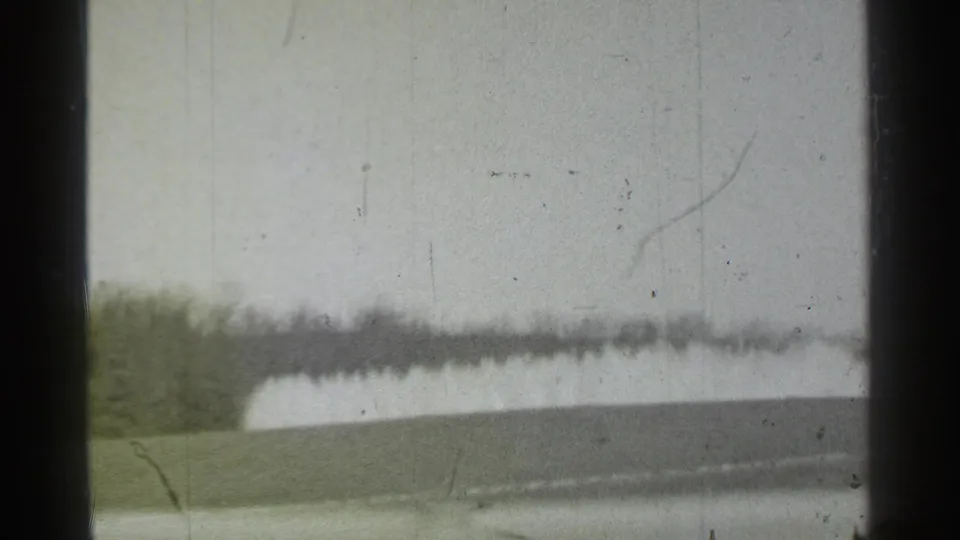 Danielson, Connecticut 1939 frame with a hazy outdoor view, likely adjacent to the pharmacy scene, with visible 8mm wear.