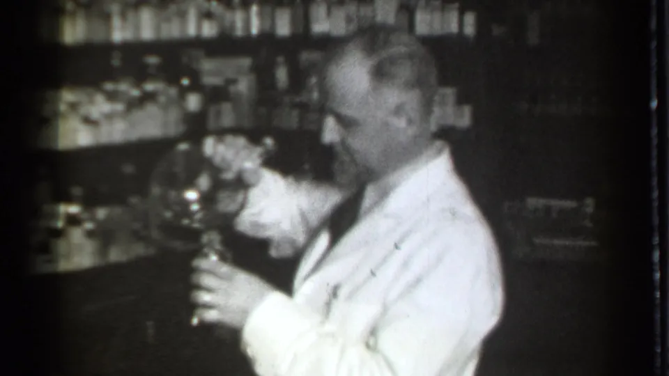 The 1939 Danielson drugstore scene shows a white-coated pharmacist looking down at glassware near shelves of small containers.