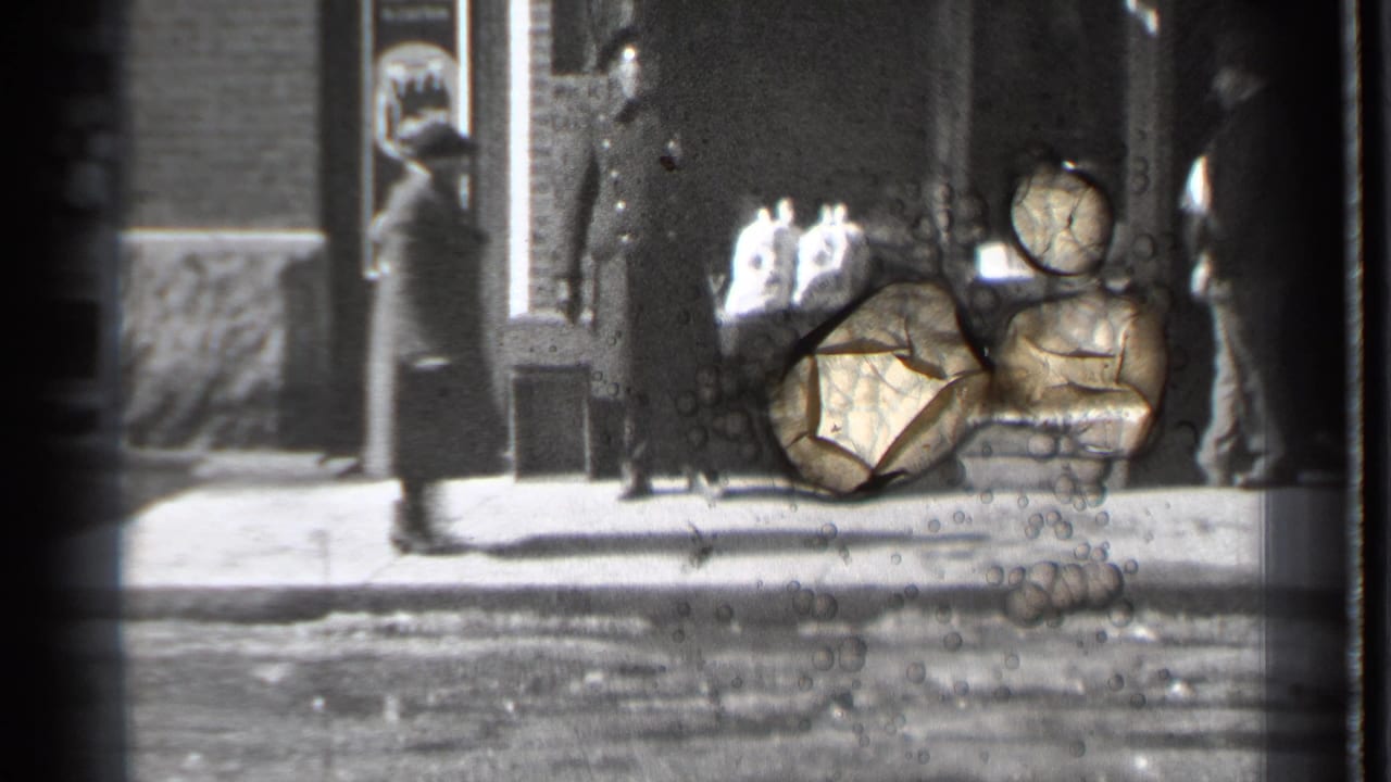 Storefront sidewalk with pedestrians and visible film damage across part of the frame.