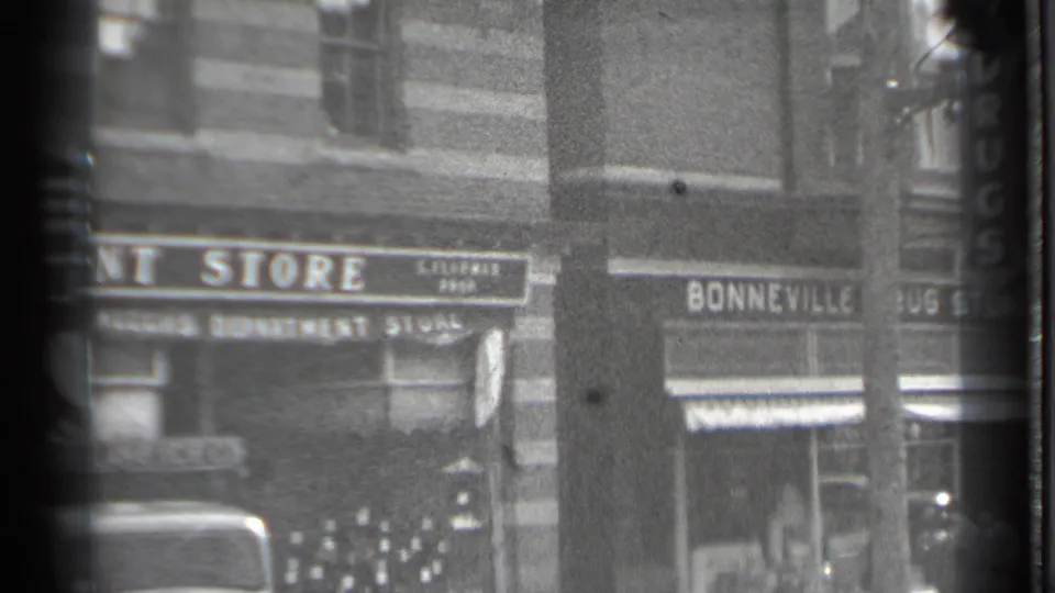 Storefront signs including Bonneville appear above parked cars and a snow-lined street in Danielson, Connecticut.