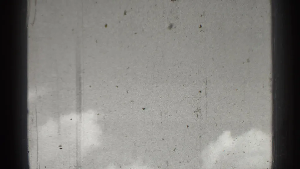 The final frame shows pale sky and clouds with dark gate edges, dust, scratches, and soft 8mm exposure.