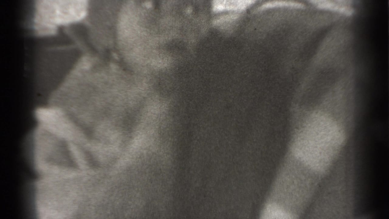 Infant in a car seat or backseat area, seen in soft focus from close range.