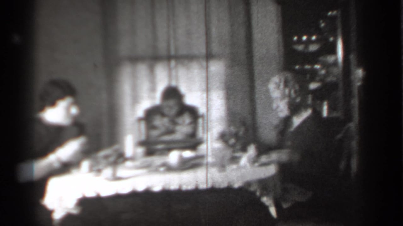 Woman at left and older adult at right seated near a child at the dining table.