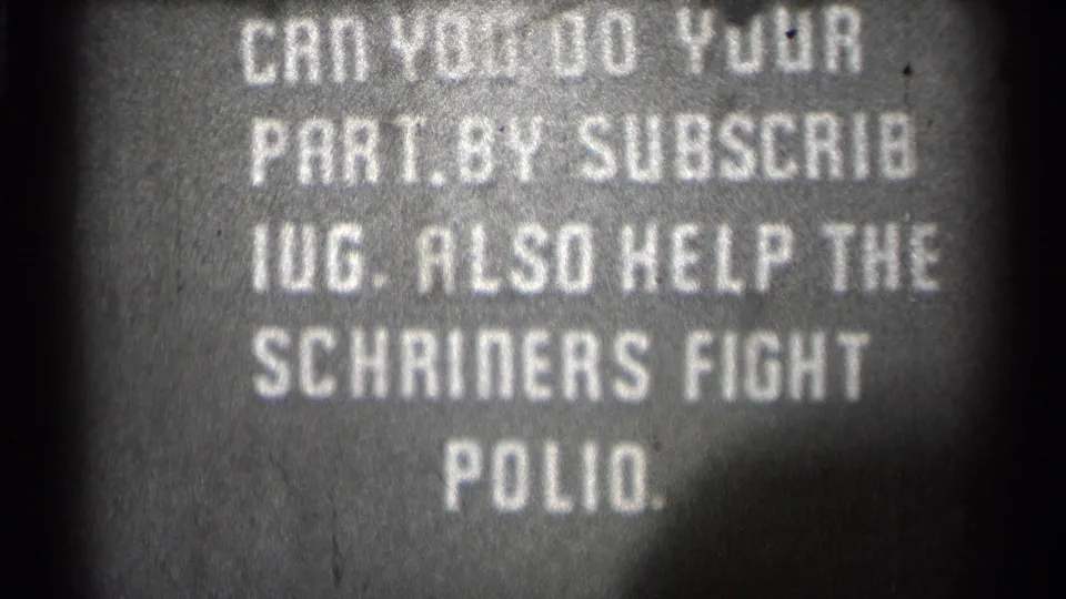 Grainy 8mm frame of the same 1944 public-service card, with white block lettering on a dark background.