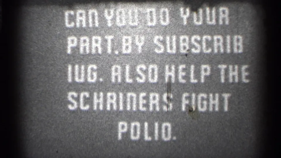 Grainy black-and-white 8mm frame from the 1944 San Francisco clip showing the polio support message near the end.