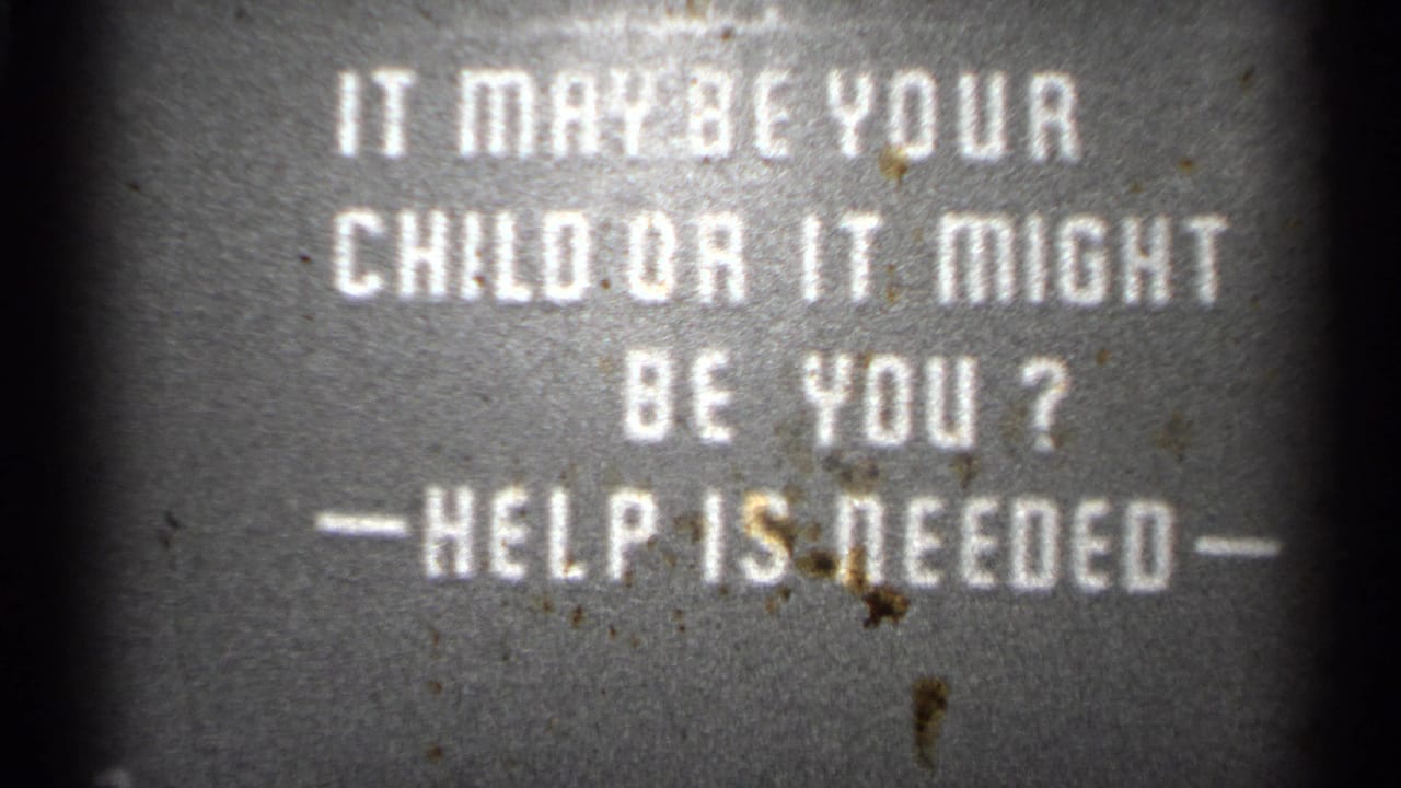 1944 metadata-supported San Francisco 8mm frame showing a white text warning card asking if help is needed.