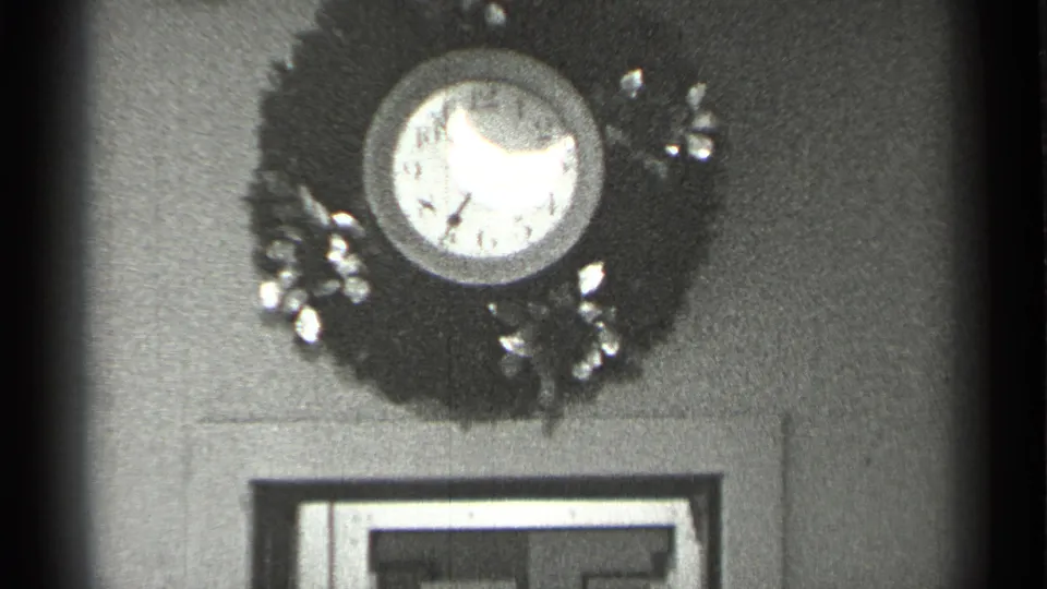 A slightly lower 8mm view shows the decorated wall clock over doorway trim in a 1944 San Francisco interior.