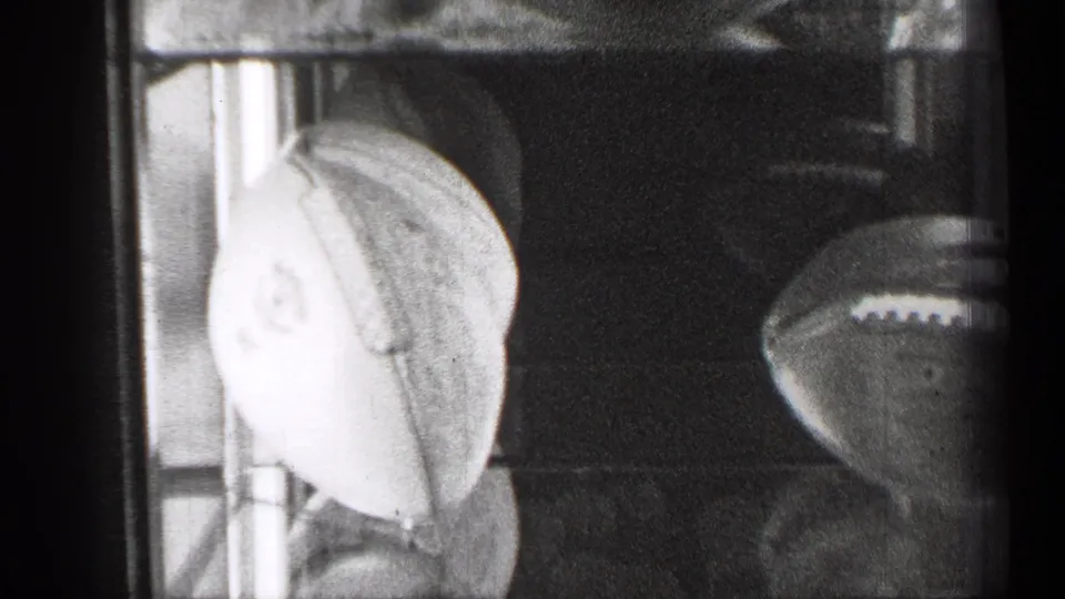 A lower section of the 1944 display case shows a pale sports ball, shelving, reflections, and another football shape at the side.