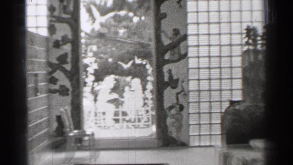 1944 San Francisco interior frame showing a carved panel, shoji-style screens, and part of the tabletop Japanese-style display.