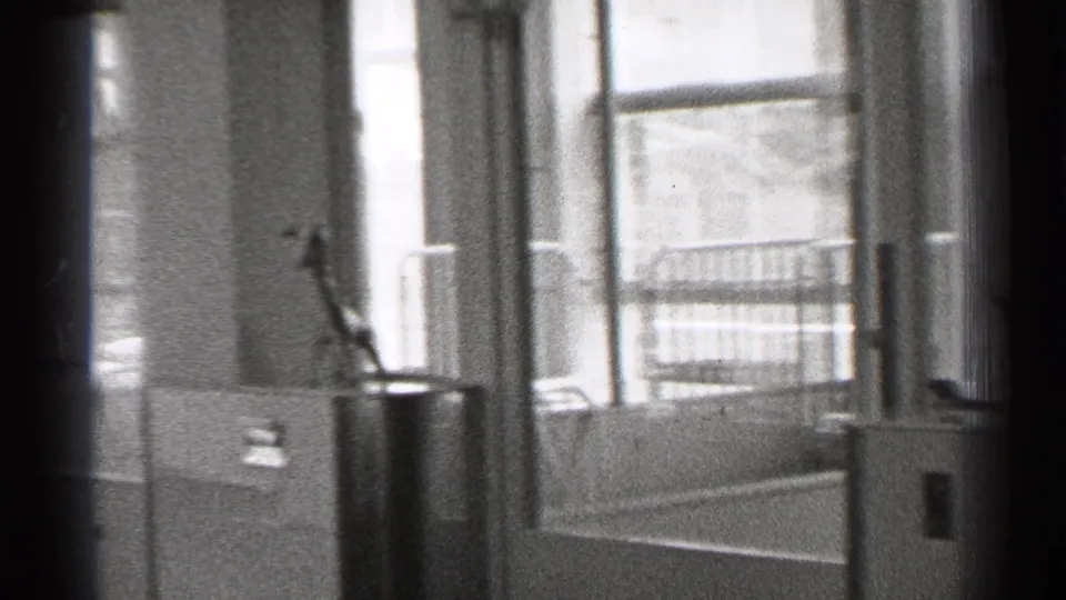 1944 San Francisco interior with tall windows, a potted plant, and household architectural details visible in soft 8mm footage.