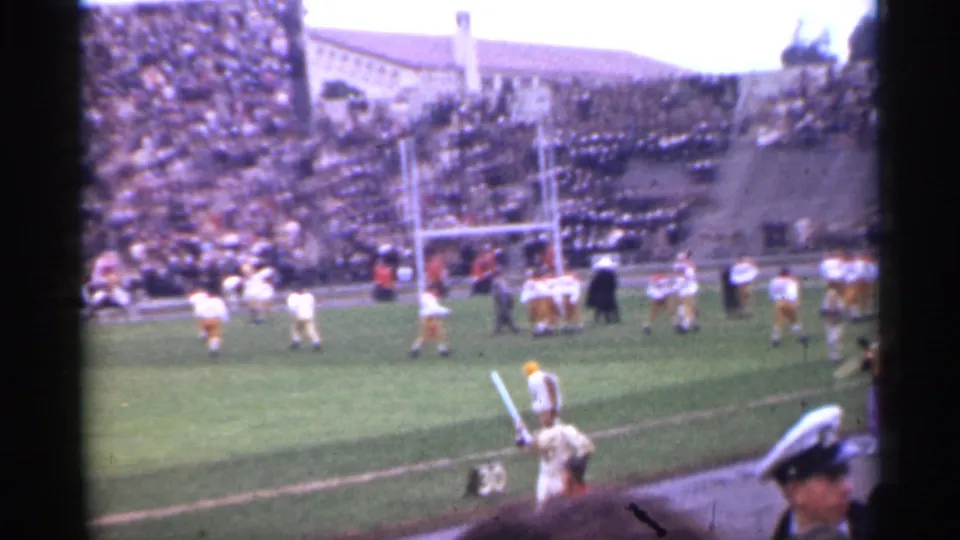 1944 San Francisco stadium view with players near the goalposts, spectators in the stands, and sideline activity in the foreground.