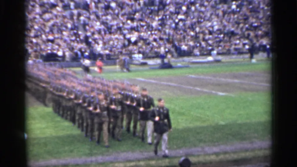 Uniformed soldiers march in organized rows across a San Francisco stadium field during a 1944 public ceremony.