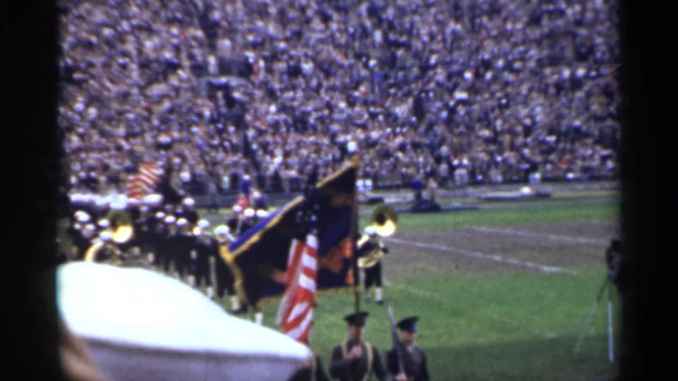 San Francisco 1944 stadium ceremony showing uniformed flag bearers in front of brass musicians and densely filled stands.