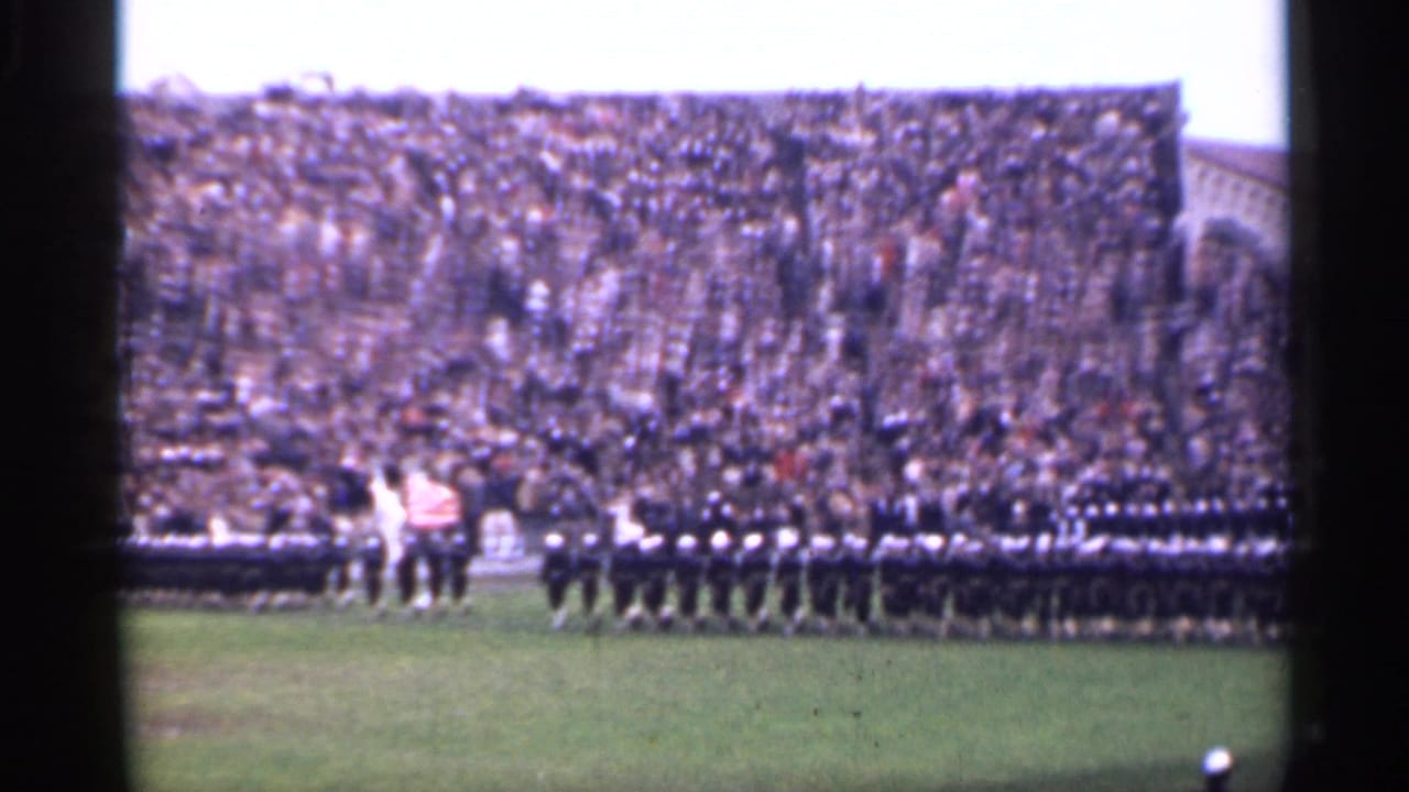 1944 San Francisco stadium frame with a wide view of uniformed rows, several flags, and a large audience in the grandstands.