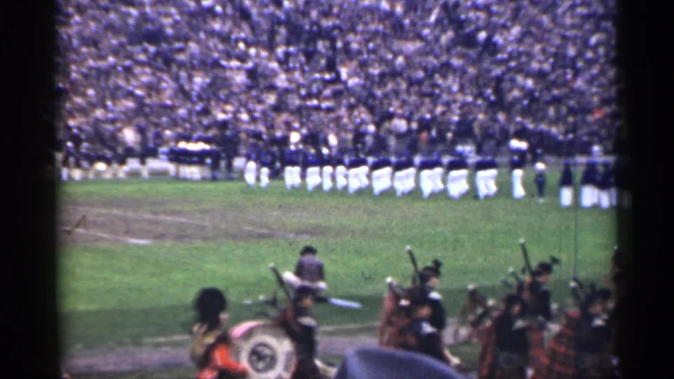 1944 San Francisco stadium scene with a marching band in white pants on the field and pipe band figures partly visible below.