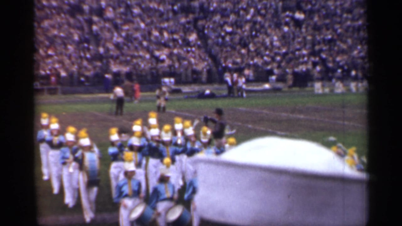 Uniformed youth marching band members perform on a San Francisco stadium field in a 1944 home-movie frame.