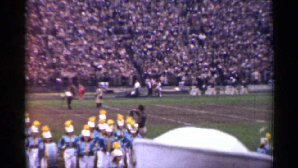 San Francisco stadium view from 1944 showing a marching band passing below the camera with spectators behind.