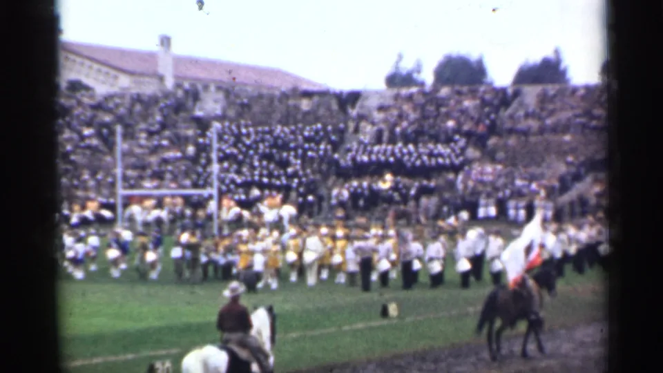 1944 San Francisco stadium scene with a marching band on the field, horseback riders near the sideline, and packed bleachers behind them.