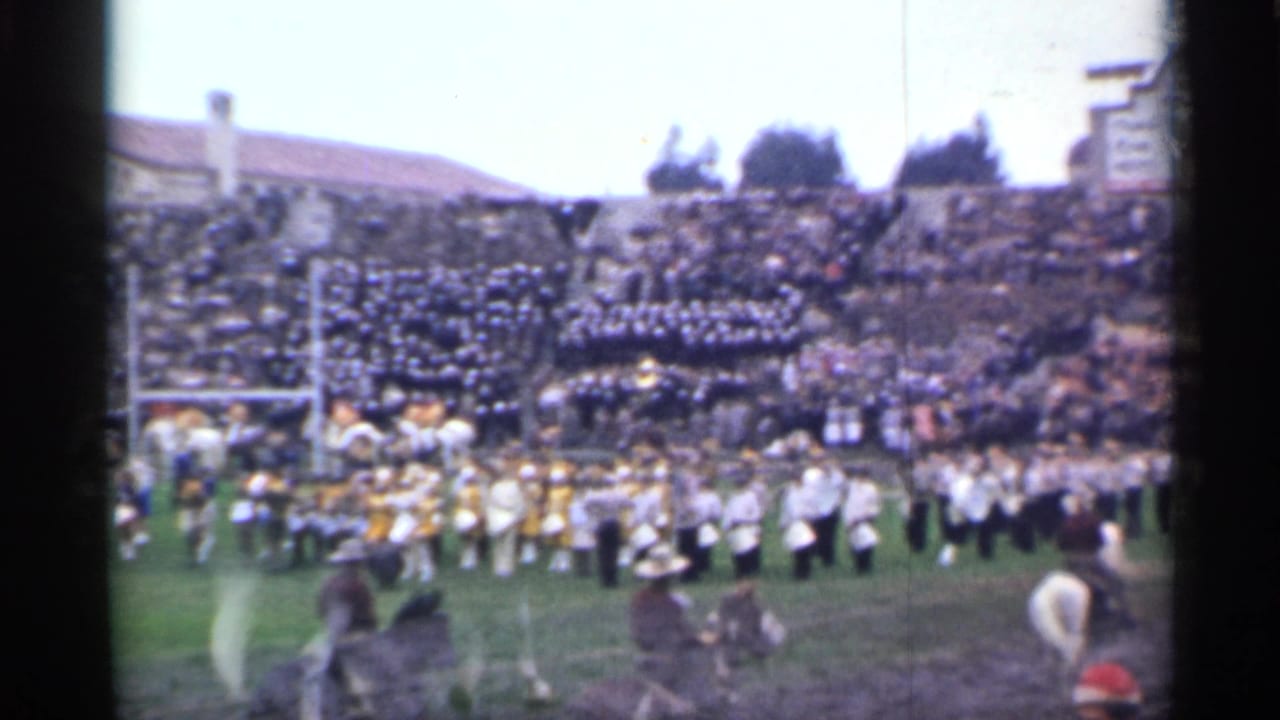 A wide 1944 San Francisco stadium view shows musicians in formation, mounted participants, a full crowd, and part of a scoreboard at the edge.