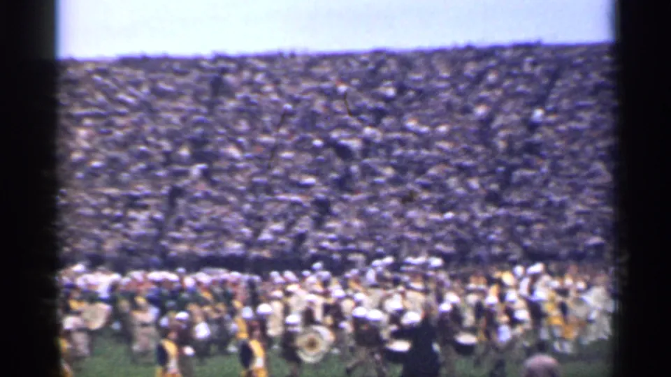 San Francisco stadium scene from 1944 showing a band formation moving across the field below a dense crowd in open-air seating.