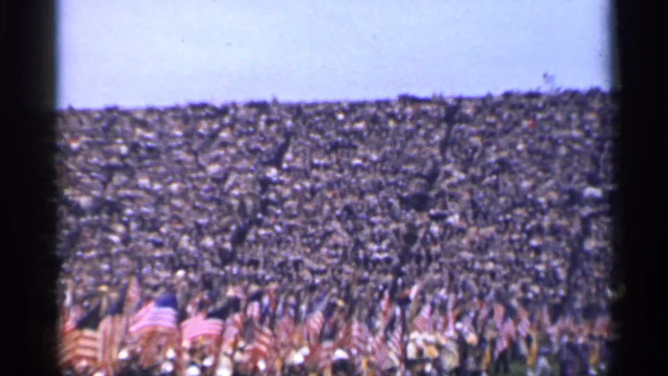 Final frame from the short 8mm clip shows flag bearers before a crowded San Francisco stadium gathering in 1944.