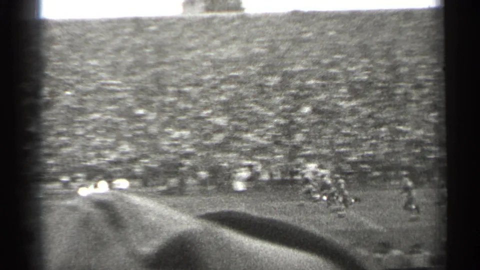 1944 San Francisco football game seen from high in the stands, with a packed crowd and players moving across the field.