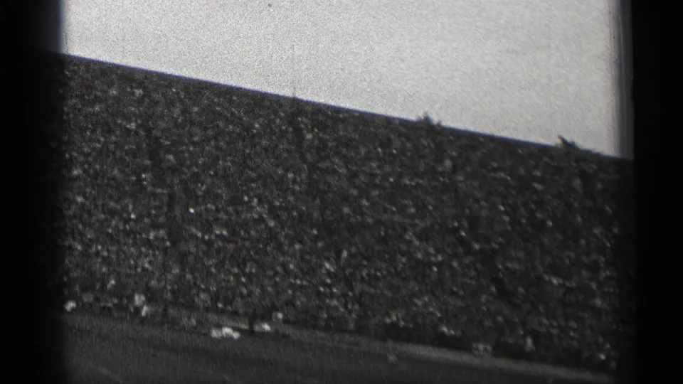 Black-and-white 8mm frame of a crowded San Francisco football stadium in 1944, with the field barely visible at the bottom.