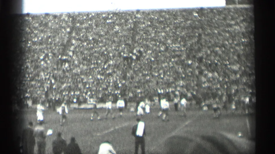 1944 San Francisco football game seen from a high spectator angle, showing players spread across the field and a full grandstand behind them.