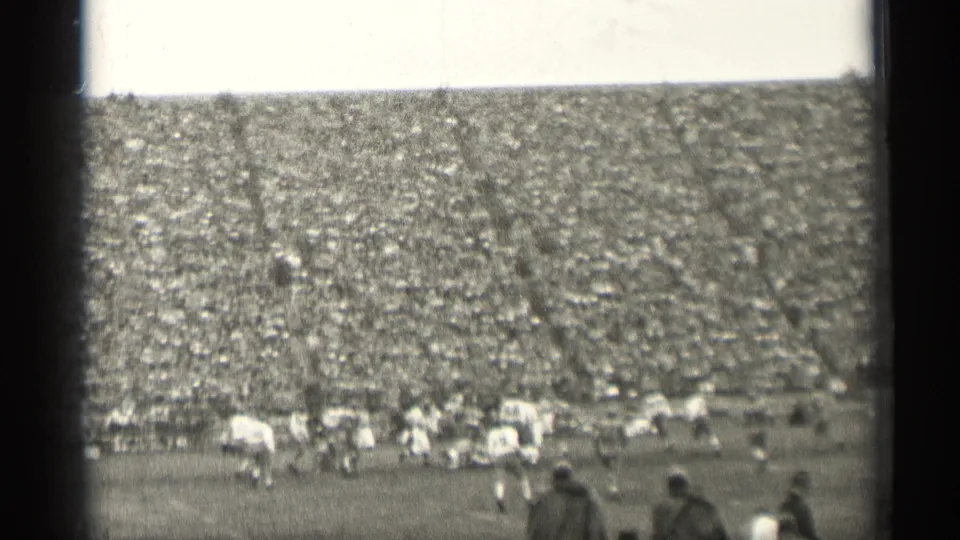 1944 San Francisco football game view from the stands, with players on the field and a dense crowd filling the stadium seats.
