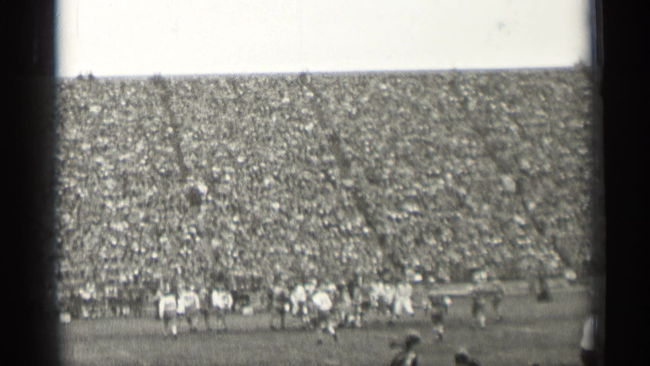 Wide 1944 San Francisco stadium view showing football play in progress beneath a tightly packed spectator section.