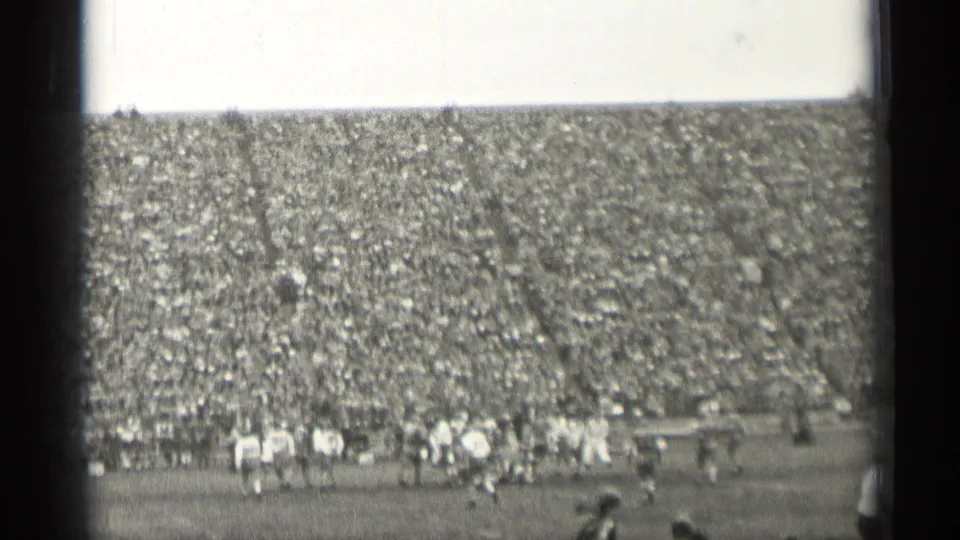 Wide 1944 San Francisco stadium view showing football play in progress beneath a tightly packed spectator section.