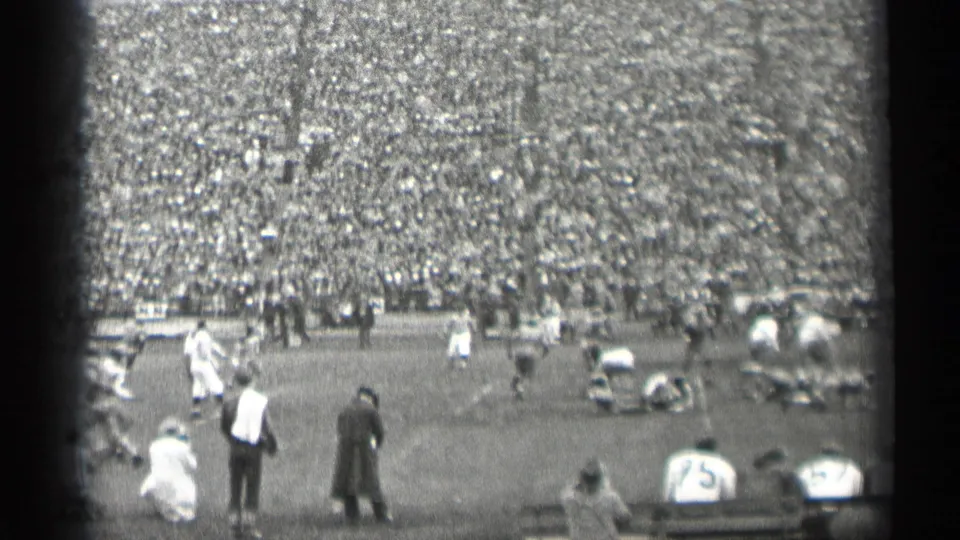 The final frame shows sideline activity, players on the field, and a large San Francisco stadium crowd in black-and-white 8mm footage.
