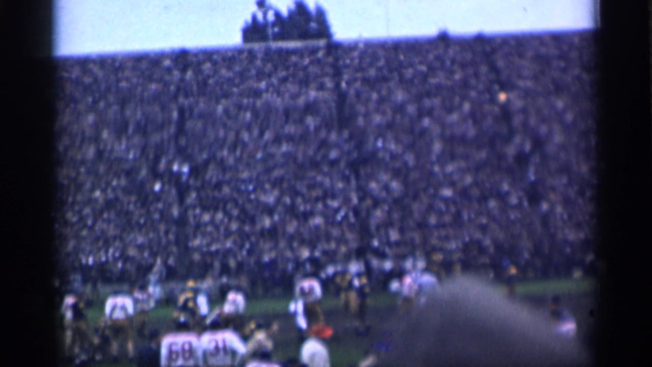 A mid-1940s football play in San Francisco, filmed from the stands with a large crowd across the far side of the field.