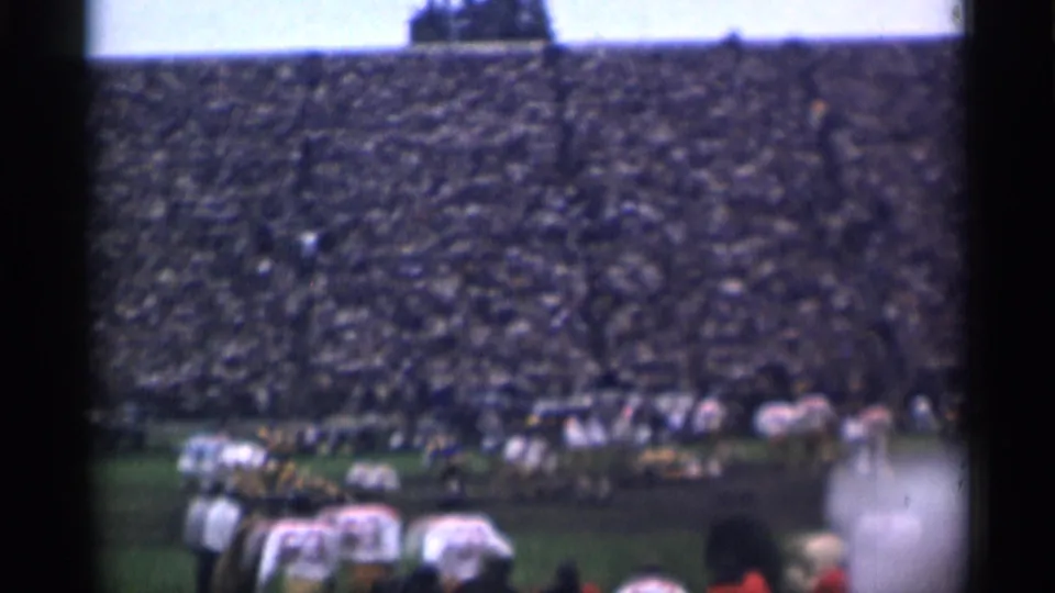 San Francisco football game footage from 1944 with teams aligned across the field and a full stadium behind them.