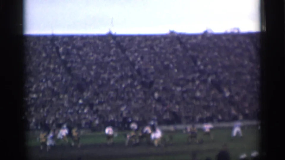 1944 San Francisco home-movie view of players on a field with densely filled stadium seating behind them.