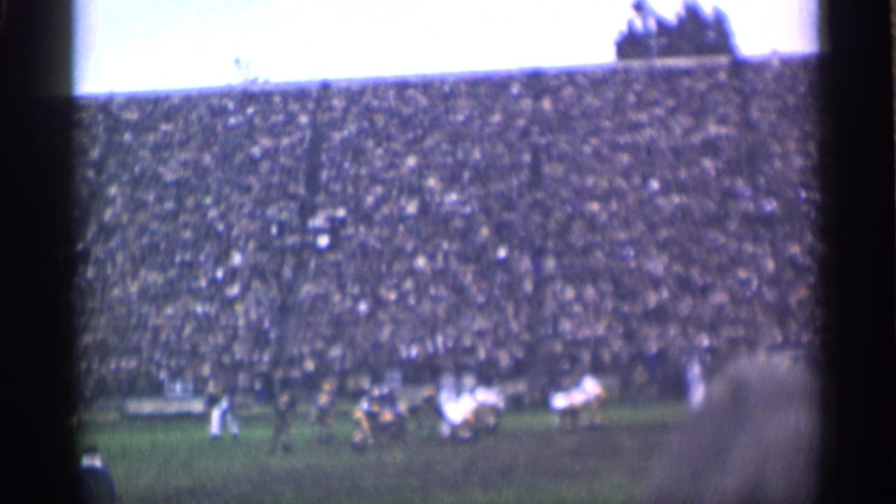 Field play continues in front of crowded stadium seating.