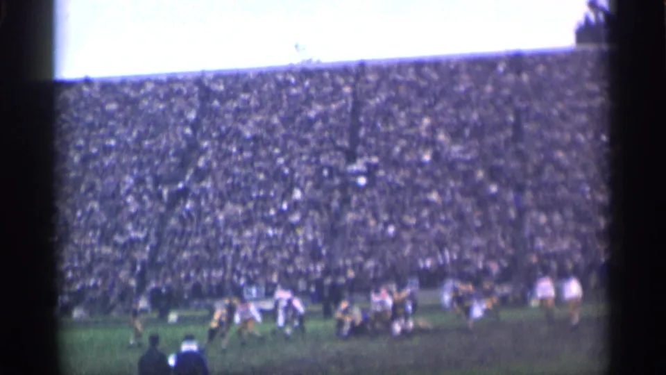 The final frame shows distant players and officials on a green field, with a large 1944 San Francisco stadium crowd behind them.
