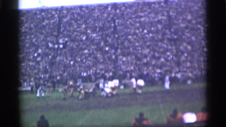 1940s San Francisco football footage showing distant players, sideline activity, and a packed grandstand.