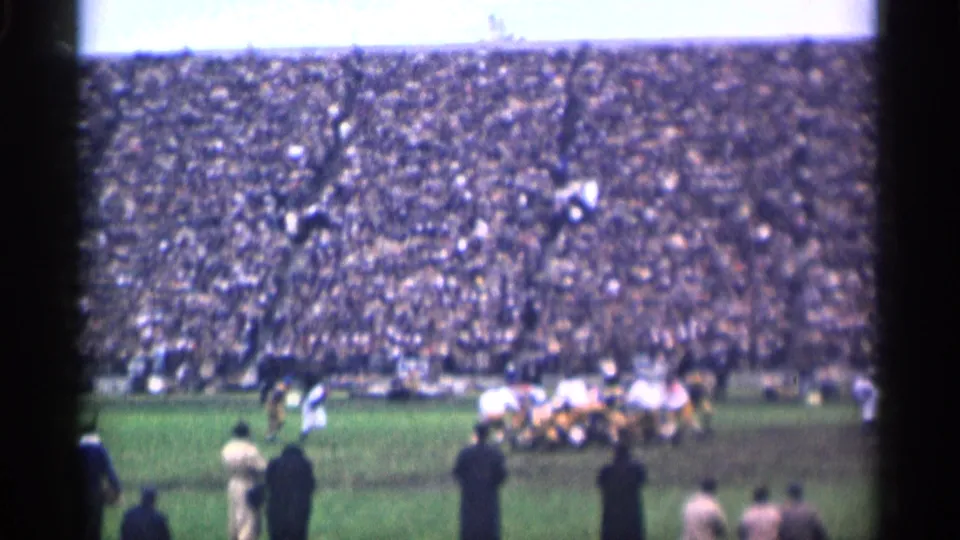 1944 San Francisco football game seen from the stands, with players converging near midfield before a large crowd.