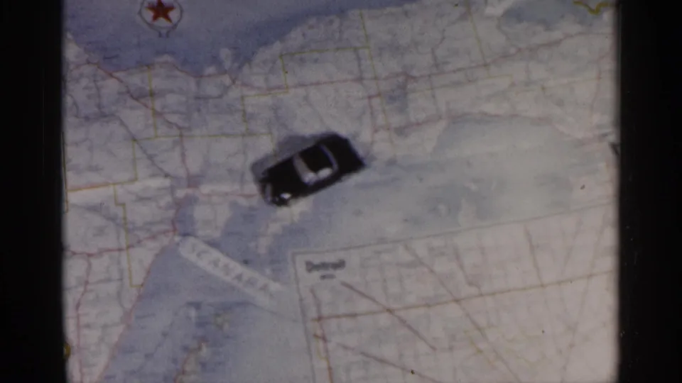 The car remains on the Michigan map, surrounded by pale map shading, red road lines, and a red star marker.
