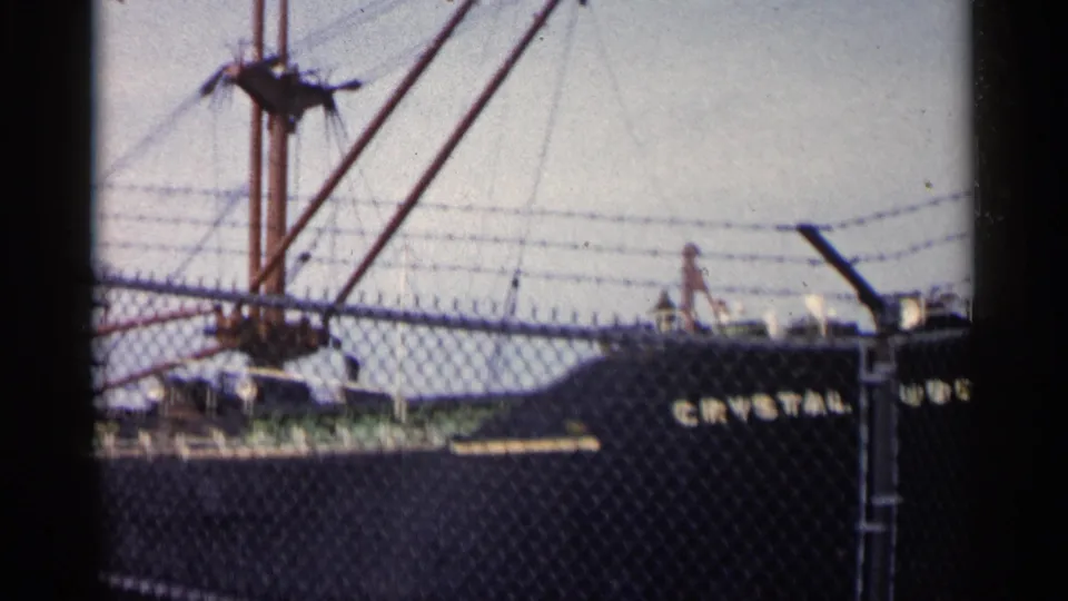 The final frame shows the Crystal Cube partly cut off at the right, with fence mesh, barbed wire, rigging, and dock structures in view.
