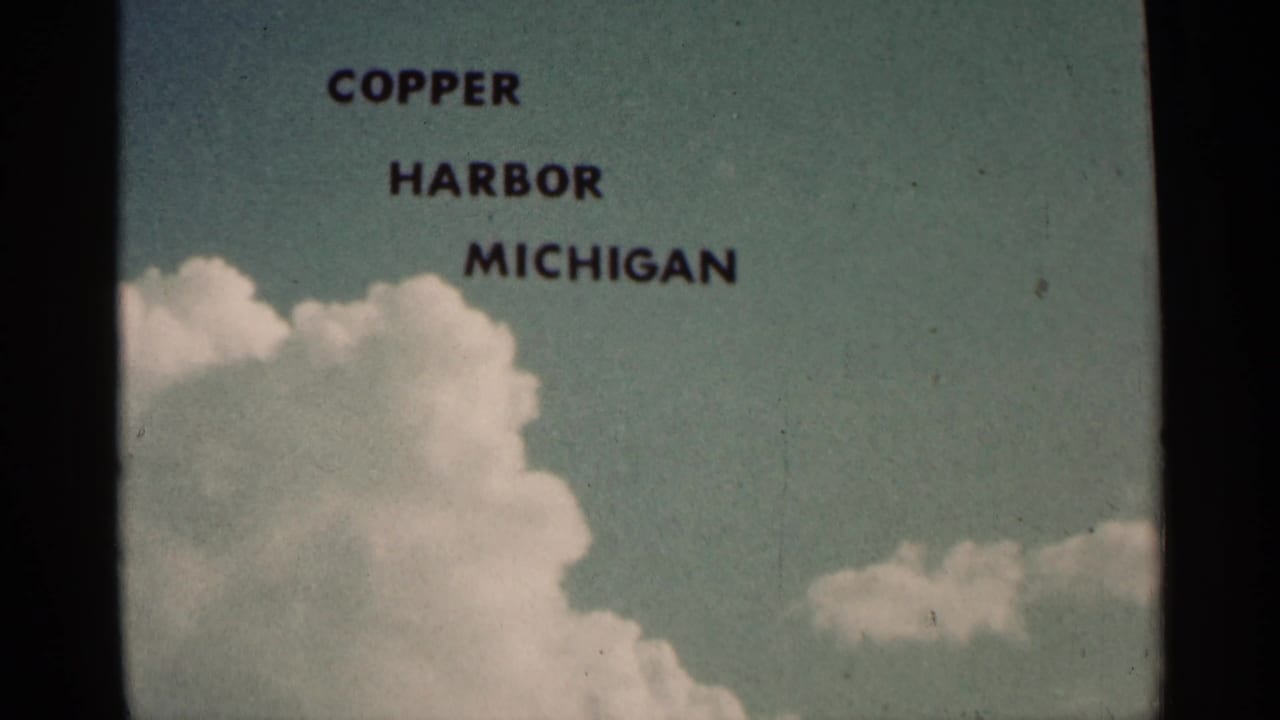 Copper Harbor Michigan title remains over sky, clouds, and dark vertical film borders.