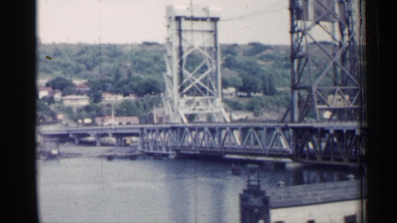 Closer view of the steel bridge tower and truss above the river.
