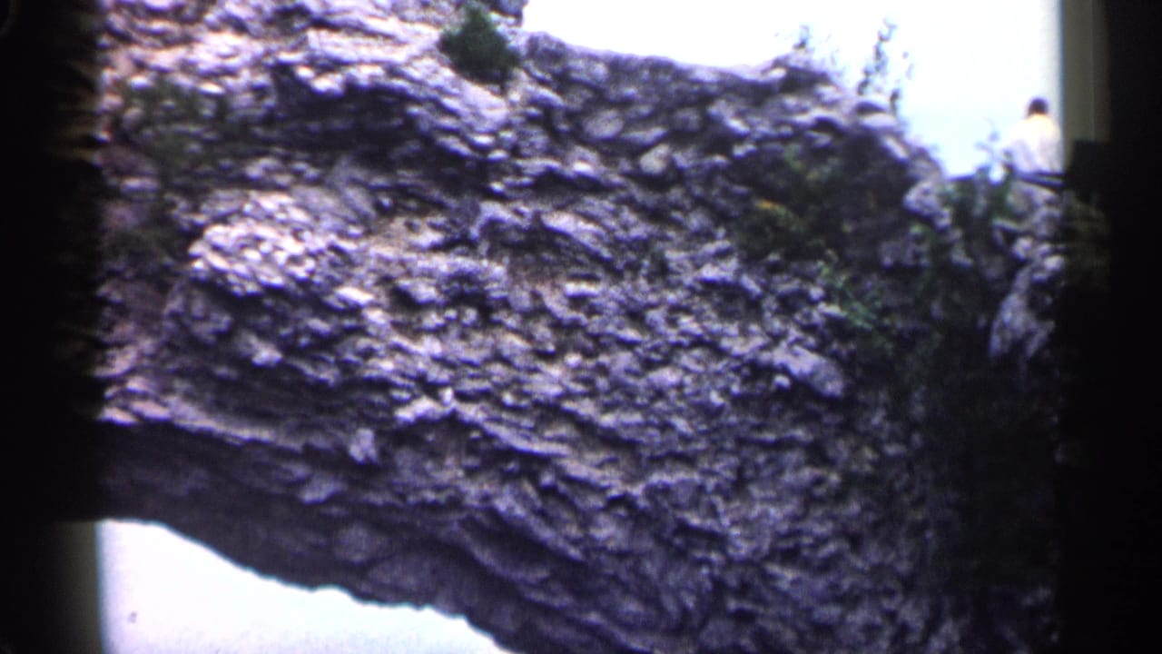 Close view of rough layered rock with bright background at the edge.
