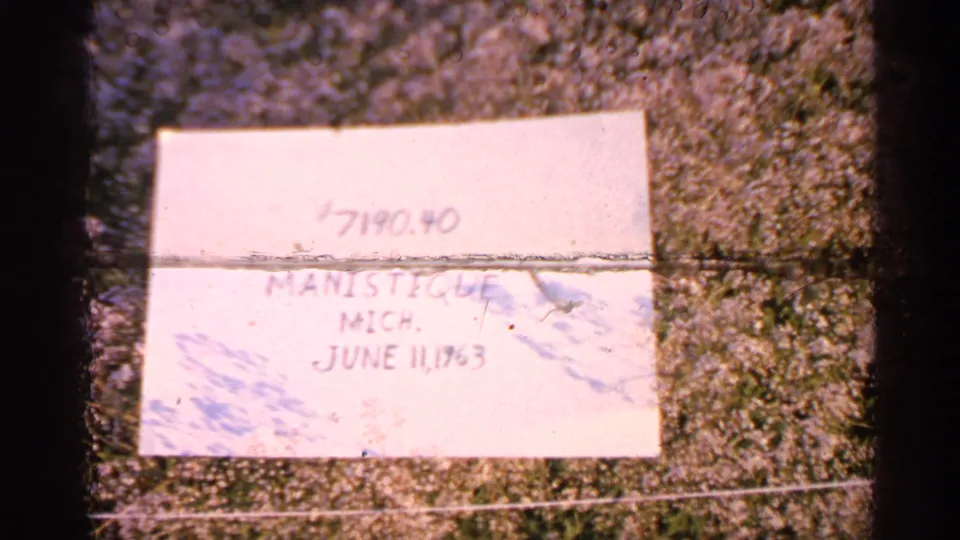 Handwritten reel label on grass documents Manistique, Michigan and June 11, 1960, though the paper is partly faded and creased.
